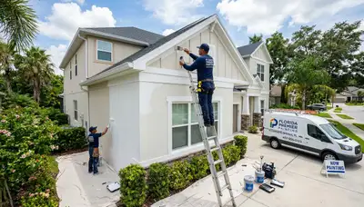 Professional house painters restoring home exterior in Orlando FL with high-quality paint finish