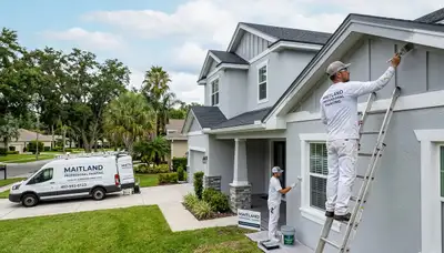 Professional house painters working on an exterior home repaint in Orlando, FL