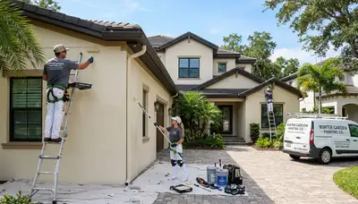 Professional house painters in Orlando FL applying exterior paint to a residential home façade